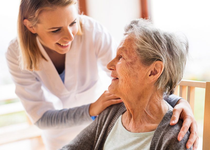 nurse-smiling-with-home-health-patient